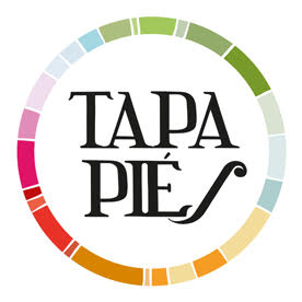 Logotipo circular multicolor con el texto TAPA PIÉS sobre fondo blanco